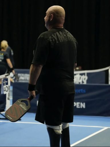 Back of mark Fosbrook holding a Pickleball paddle